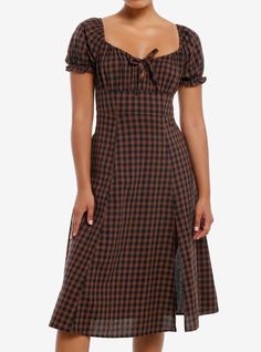 This dress makes us think of a cozy  cool night in a cottage! It's an empire waist midi dress with a black and brown checkered pattern  puff sleeves and a drawstring at the bust. There's a slit on the left side.100% cottonWash cold; dry lowLength: 41"ImportedListed in junior sizesModel is 5'9"Model wears size Small Black And Brown Checkered Dress, Brown Gingham Dress, Casual Winter Dresses, Fall Dresses Casual, Dark Cottagecore Fashion, Plaid Dress Outfit, Cozy Dresses, Red Checkered Dress, Empire Waist Midi Dress