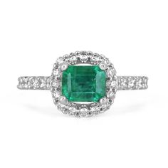 Behold a mesmerizing emerald and diamond engagement ring that captures the essence of timeless elegance. Featuring a magnificent 1.70-carat emerald cut emerald, the vibrant gemstone takes center stage as it is set horizontally, east to west, within secure prongs. The emerald dazzles with a lush and rich green color, boasting beautiful characteristics that reflect its natural allure. Surrounding the emerald, a brilliant round cut diamond halo, intricately pave-set, adds a captivating brilliance and enhances the emerald's beauty. The diamond-adorned shank gracefully extends halfway down, perfectly crafted in lustrous 14k white gold, completing this exquisite symbol of everlasting love. Setting Style: Prong/Pave Setting Material: 14K White Gold Setting Weight: 3.5 Grams Main Stone: Emerald Sh Fine Jewelry Emerald Ring With Platinum, Emerald Ring With Center Stone In 14k White Gold, Gia Certified Green Platinum Cluster Ring, Classic Green Cluster Ring In Platinum, Dazzling Platinum Emerald Ring With Center Stone, Dazzling Platinum Emerald Ring, Elegant Gia Certified Emerald Cluster Ring, Classic Green Platinum Cluster Ring, Green Brilliant Cut Platinum Halo Ring