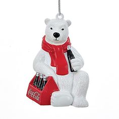 a white polar bear ornament holding a coke cola can