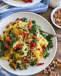 two white plates filled with pasta and vegetables