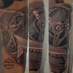 a man's arm with a clock and gears tattoo on it