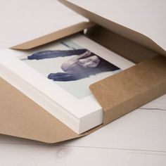 an open cardboard box with a photo inside