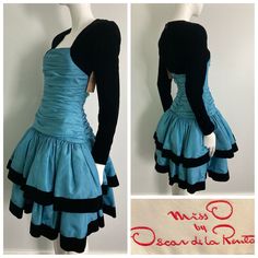 "Beautiful 1980s Miss O by Oscar de la Renta dress. Gorgeous blue taffeta with tule layered under each tier, black velvet sleeves and trim on skirt. This label is a step down from couture, and is constructed beautifully. Center back zipper closure, gathered bodice, this dress is quite heavy and full. There are a few faint small water marks on the skirt that are not very noticeable but mentionable. as this item has not yet been cleaned and  we have priced it accordingly. It's an absolutely stunning dress and really shows it quality and design Bust: 32\" Waist: 26\" Hip: 32-34\" Sleeve: 23.25\" Length: 39.25\" If you have any questions or would like more information about this listing, please don't hesitate to ask." 80s Fashion Formal Classy, Layerd Dress, 1980's Dresses, Dynamic Clothes, Perfect Blue Dress, 2000 Dresses, Short Dress Outfit, Blue Dress With Sleeves, Layered Clothes