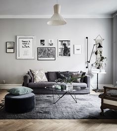 a living room filled with furniture and pictures on the wall