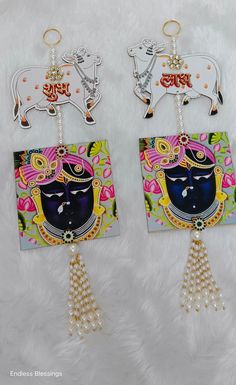 the earrings are decorated with an image of a bull and a woman's face