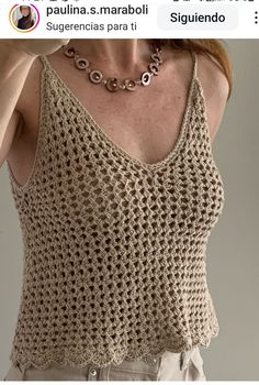 the woman is wearing a crocheted tank top