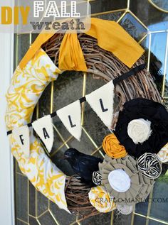 a diy fall wreath hanging on the front door with some fabric and yarn around it