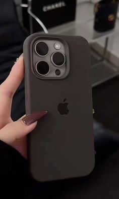 a person holding an iphone in their hand with the case on it's side