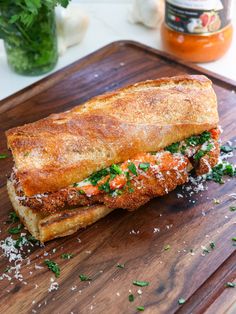 a sandwich on a cutting board with parmesan cheese