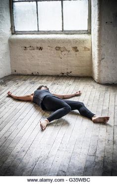 a man laying on the floor in front of a window