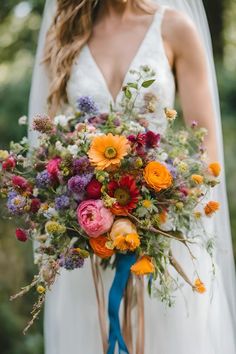 a bride holding a bouquet of flowers in her hands