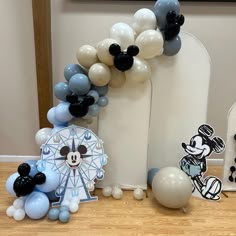 some balloons and mickey mouse decorations on a table