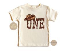 "Birthday Kids Shirt\" is perfect for your little cowboy's first birthday celebration! With its charming western theme and cute design, it adds a touch of cowboy flair to any birthday party. Made from high-quality, comfortable fabric, it ensures your little one stays stylish and comfy all day long. Whether you're celebrating on the farm or in the city, this tee is sure to make your little cowboy's birthday extra special. Handmade 100% cotton items How to order: Please select size & style from the drop down menu, select quantity If there is personalization box available(for certain listings) Add your personalization Add to cart If you are ordering multiple shirts with different size & style Add them to the cart separately Then proceed to checkout If in rush, please select priority mail opti How The West Was One Birthday Shirt, Coastal Cowgirl Decor, Cowboy First Birthday, Coastal Cowgirl Aesthetic, Wild West Birthday, 1st Rodeo, Cowgirl Decor, Newspaper Poster, First Birthday Shirt