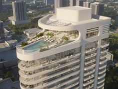 an aerial view of a building with a pool in the middle and lots of buildings around it