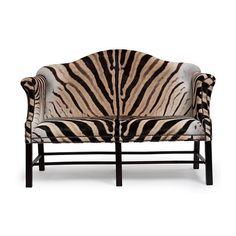 a zebra print couch sitting on top of a white floor next to a wooden frame