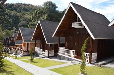 several wooden cabins with white balconies and porches