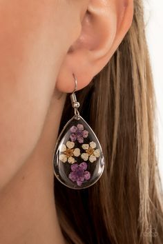 Dainty yellow and purple flowers are encased in a glassy teardrop, creating a whimsical frame. Earring attaches to a standard fishhook fitting.

 Sold as one pair of earrings. Multi Earrings, Jewelry Watch, Yellow And Purple, Fish Hook Earrings, Paparazzi Accessories, Floral Fashion, White Rhinestone, Paparazzi Jewelry, Shiny Silver