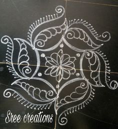 a black table with white designs on it and the words free creations written in chalk