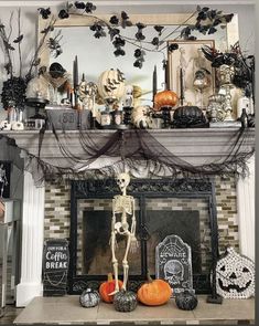 a fireplace decorated for halloween with skeletons, pumpkins and other decorations on the mantle