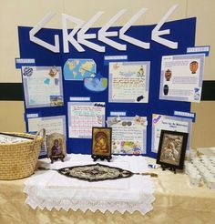 a table topped with pictures and other items on top of a white cloth covered table