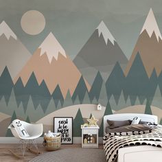 a bedroom with mountains painted on the wall and a rocking chair in the foreground