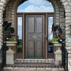 the front door is decorated with potted flowers and decorative iron work on it's sides