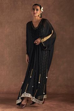 Black kaftan with paan-patti motif embroidered on sleeve, gota and tassel accents with gathered waist. Comes with an all-over irisbud foil printed slip. - Aza Fashions Traditional Kaftan With Tassels, Bollywood Style Festive Kaftan With Tassels, Festive Traditional Kaftan With Tassels, Elegant Long Sleeve Kaftan With Tassels, Traditional Tassel Kaftan With Drape, Traditional Tasseled Kaftan, Festive Embellished Kaftan With Kimono Sleeves, Black Traditional Drape Kaftan For Festive Occasions, Traditional Long Sleeve Kaftan With Tassels