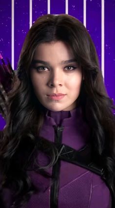 a woman with long dark hair wearing a purple outfit