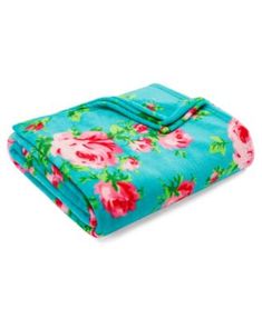 a blue blanket with pink flowers on it