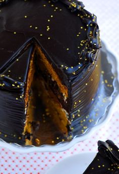 there is a chocolate cake with gold sprinkles on it