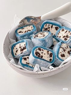 a bowl filled with blue and white marshmallows