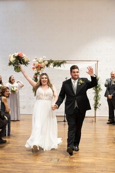 a bride and groom walking down the aisle