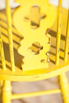 a yellow chair with holes in the back