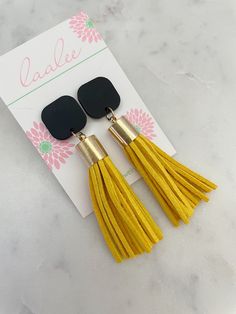 "These black and yellow tassel earrings are the perfect simple statement piece for gamedays or great for teacher or holiday gifts! Measures approximately 2.75\" in length. Giftbox included!" Yellow Fringe Earrings As Gift, Black Drop Tassel Earrings As Gift, Yellow Tassel Earrings As Gift, Black Tassel Earrings As Gift, Elegant Yellow Tassel Earrings For Gift, Yellow Dangle Tassel Earrings For Party, Yellow Dangle Tassel Earrings Gift, Black Tassel Earrings For Gift, Yellow Tassel Earrings For Festival