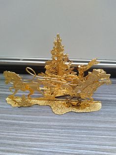 a gold brooch sitting on top of a table