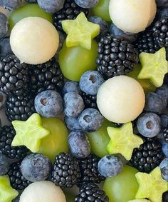 grapes, blackberries and other fruits are arranged together