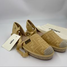 Visit Us At Https://Www.Shopluxeforall.Com To Purchase This Item At Discounted Price! Fendi Yellow Ff Logo Cotton Embroidered Tie Up Flat Espadrilles. New With Tag And Dust Bag. Size 38 Ff Logo Embossed Canvas Espadrilles. 1" Flat Heel With Braided-Jute Trim. Round Cap Toe. Adjustable Ankle-Wrap Ties. Rubber Sole. Tie Up Flats, Embroidered Tie, Ff Logo, Ankle Wrap, Fendi Shoes, Flat Espadrilles, Espadrille Shoes, Rubber Sole, Espadrilles