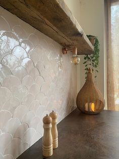 a kitchen counter with two salt and pepper shakers on it