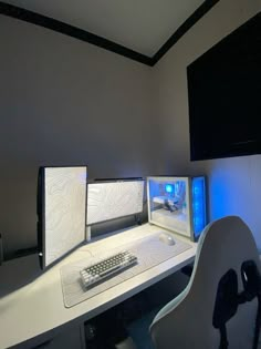 two computer monitors sitting on top of a white desk