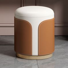 a white and brown ottoman sitting on top of a floor