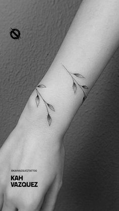 a woman's arm with leaves on it