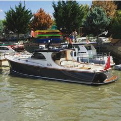 several boats are docked in the water at a dock