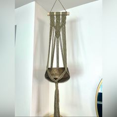 a hammock hanging from a rope in the corner of a room with a mirror