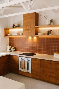 a kitchen with wooden cabinets and tile backsplash, white counter tops and beige flooring