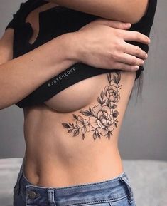 a woman with a flower tattoo on her stomach