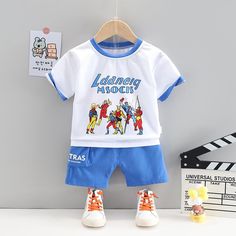 Toddler Boy Superman Pattern Shirt T-shirt & Shorts Wholesale Children's Clothing - PrettyKid Short Sleeve Sets With Letter Print For Playtime, Short Sleeve Sets With Cartoon Print For Playtime, Playtime Character Print Short Sleeve Sets, Playtime Cartoon Print Short Sleeve Sets, Cartoon Print Playtime Sets With Short Sleeves, Playtime Sets With Character Print And Short Sleeves, Blue Short Sleeve Sets With Letter Print, Blue Letter Print Summer Sets, Blue Summer Sets With Letter Print