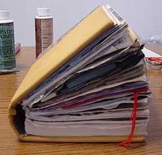 a stack of papers sitting on top of a wooden table