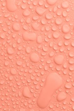 an orange background with water drops on it