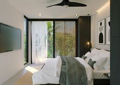 a bedroom with a ceiling fan and sliding glass doors