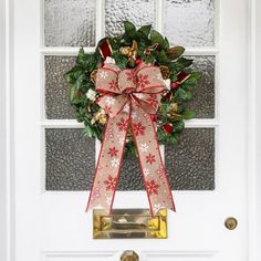 a christmas wreath hanging on the front door